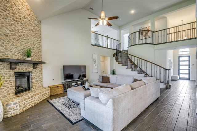 539 Curtiss Dr, Fate, TX 75087 - living room with high vaulted ceiling, stairs, wood tiled floors, ceiling fan, and a stone fireplace