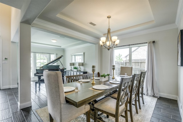 539 Curtiss Dr, Fate, TX 75087 - dining space with a raised ceiling, a chandelier, wood tiled floors, and ornamental molding