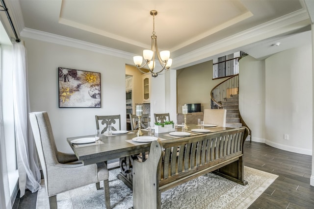 539 Curtiss Dr, Fate, TX 75087 - dining space featuring a tray ceiling, stairway, dark wood-style flooring, a chandelier, and ornamental molding