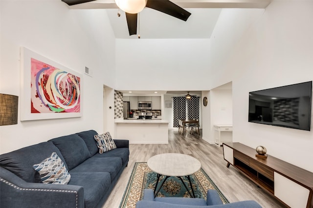 5750 Phoenix Dr Unit 39, Dallas, TX 75231 - living area featuring a ceiling fan, light wood-type flooring, and a towering ceiling