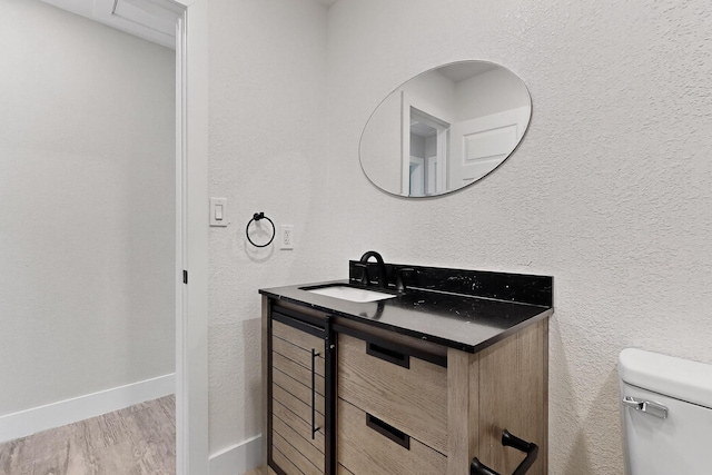5612 Meadow Nest Dr, Dallas, TX 75236 - bathroom with vanity, wood finished floors, and a textured wall