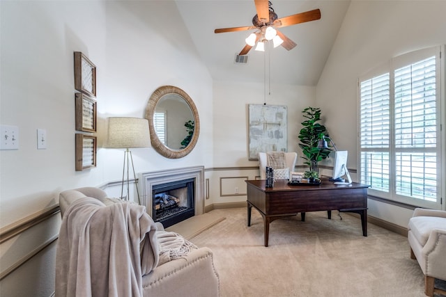 5701 Travis Dr, Frisco, TX 75034 - office area featuring light colored carpet, a ceiling fan, a fireplace with raised hearth, and high vaulted ceiling