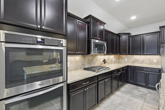 1129 Berrydale Dr, Northlake, TX 76226 - kitchen with stainless steel appliances, light stone counters, backsplash, light tile patterned floors, and recessed lighting