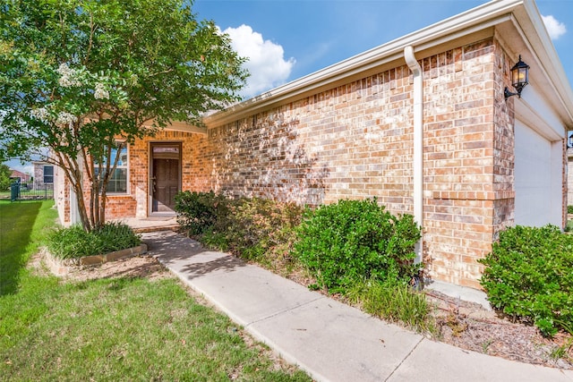 2111 Bentwater Ln, Frisco, TX 75036 - doorway to property featuring brick siding, a yard, and a garage