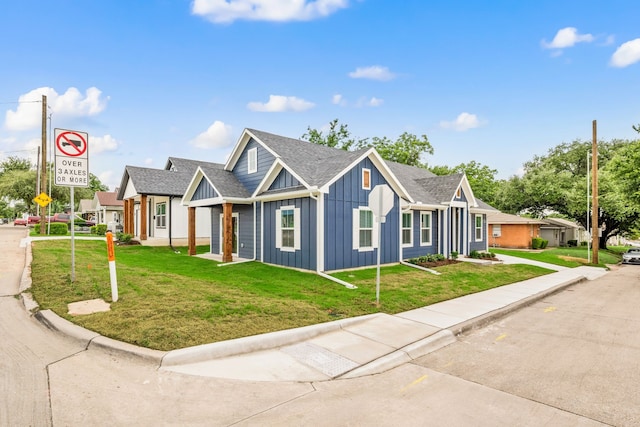 812 13th St, Plano, TX 75074 - view of front of house with board and batten siding, a front lawn, and a shingled roof