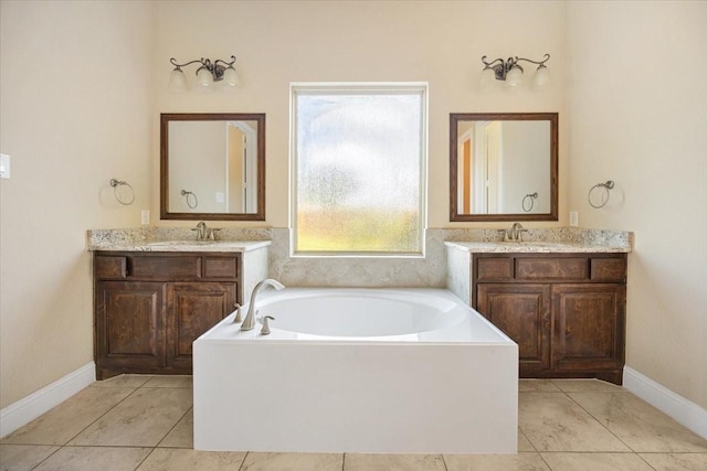 632 Fishback Cir, Plano, TX 75074 - bathroom featuring a bath, two vanities, and tile patterned flooring