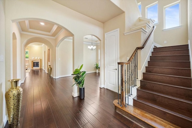 632 Fishback Cir, Plano, TX 75074 - foyer with plenty of natural light, arched walkways, stairway, ornamental molding, and dark wood finished floors