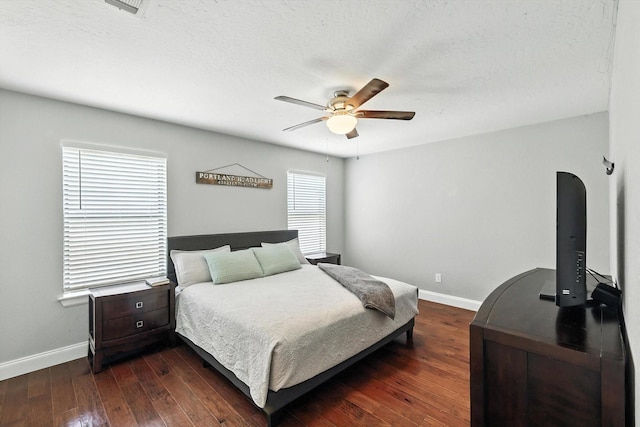 1227 Eaton Ln, Grapevine, TX 76051 - bedroom featuring dark wood-style floors, a ceiling fan, and a textured ceiling