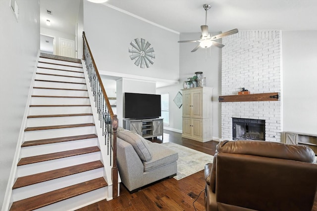 1227 Eaton Ln, Grapevine, TX 76051 - living area featuring stairway, a fireplace, dark wood-style floors, ceiling fan, and a towering ceiling