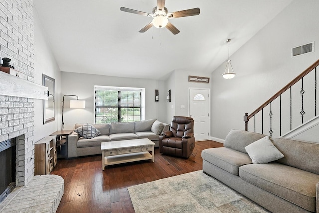1227 Eaton Ln, Grapevine, TX 76051 - living area featuring vaulted ceiling, a ceiling fan, dark wood-style floors, a fireplace, and stairway