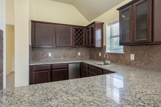 1220 Berkeley Dr, Burleson, TX 76028 - kitchen with vaulted ceiling, dark brown cabinets, glass insert cabinets, backsplash, and light stone counters