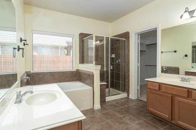 1220 Berkeley Dr, Burleson, TX 76028 - bathroom with a shower stall, two vanities, tile patterned flooring, a garden tub, and a walk in closet