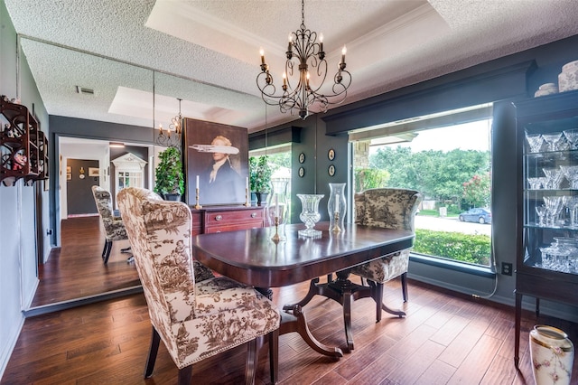 5205 Shady Springs Ct, Arlington, TX 76017 - dining area featuring a tray ceiling, a textured ceiling, a chandelier, hardwood / wood-style flooring, and crown molding