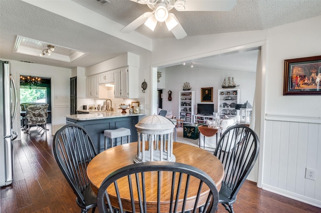 5205 Shady Springs Ct, Arlington, TX 76017 - dining area with a textured ceiling, dark wood-type flooring, ceiling fan, and a tray ceiling