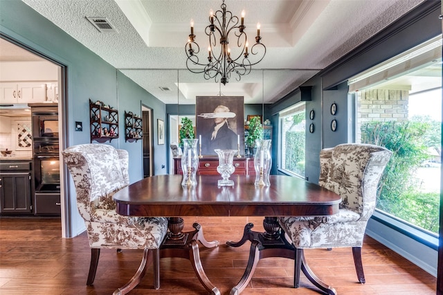 5205 Shady Springs Ct, Arlington, TX 76017 - dining area featuring a chandelier, dark wood-style flooring, crown molding, and a textured ceiling