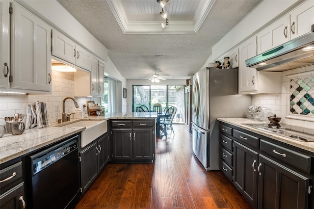 5205 Shady Springs Ct, Arlington, TX 76017 - kitchen featuring dishwasher, under cabinet range hood, a peninsula, dark wood-style floors, and electric stovetop
