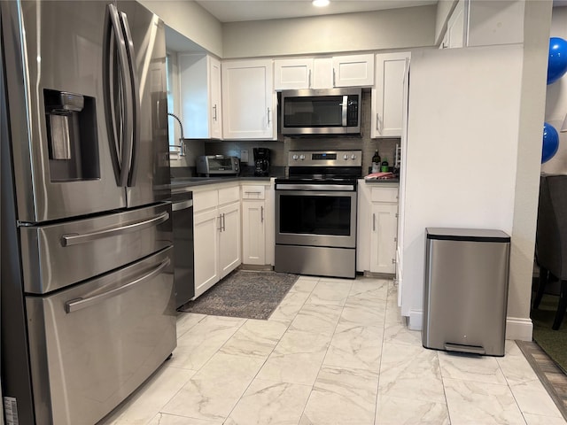 5818 E University Blvd Unit 236, Dallas, TX 75206 - kitchen featuring appliances with stainless steel finishes, light marble finish floors, white cabinets, backsplash, and recessed lighting