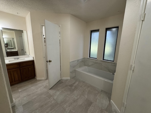 510 Betsy Ross Dr, Arlington, TX 76002 - bathroom with a garden tub, vanity, and a textured ceiling