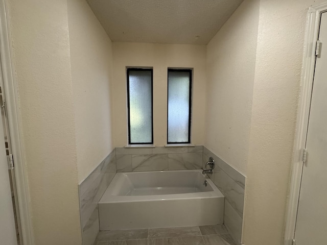 510 Betsy Ross Dr, Arlington, TX 76002 - bathroom with a bath, a textured ceiling, and a textured wall
