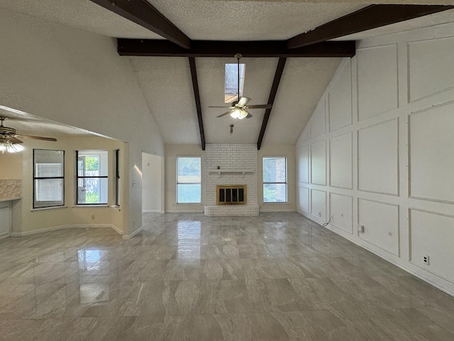 510 Betsy Ross Dr, Arlington, TX 76002 - unfurnished living room featuring a ceiling fan, a brick fireplace, beamed ceiling, healthy amount of natural light, and high vaulted ceiling