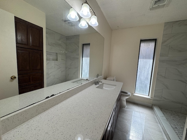 510 Betsy Ross Dr, Arlington, TX 76002 - bathroom featuring a chandelier, a walk in shower, double vanity, and a textured ceiling