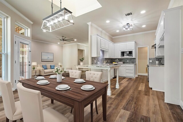 334 Pebblebrook Dr, Grapevine, TX 76051 - dining space with recessed lighting, dark wood-type flooring, crown molding, a ceiling fan, and a chandelier