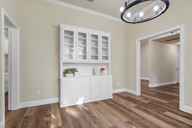 334 Pebblebrook Dr, Grapevine, TX 76051 - unfurnished dining area with a chandelier, dark wood finished floors, and crown molding