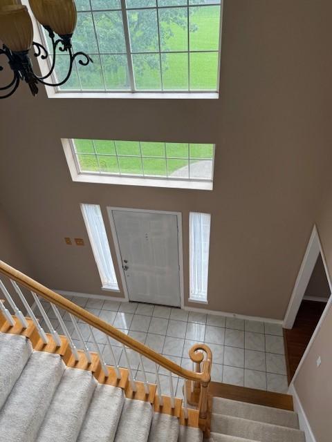 1706 Norwood St, Sherman, TX 75092 - entrance foyer with stairs, a towering ceiling, a chandelier, and light tile patterned floors