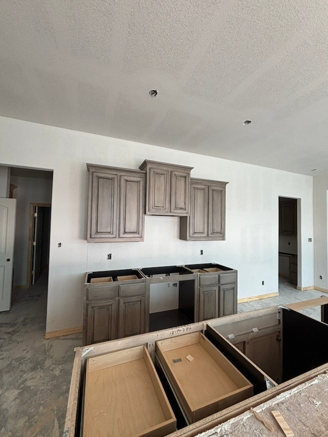 2017 Kelva Dr, Haslet, TX 76052 - kitchen with a textured ceiling and concrete flooring