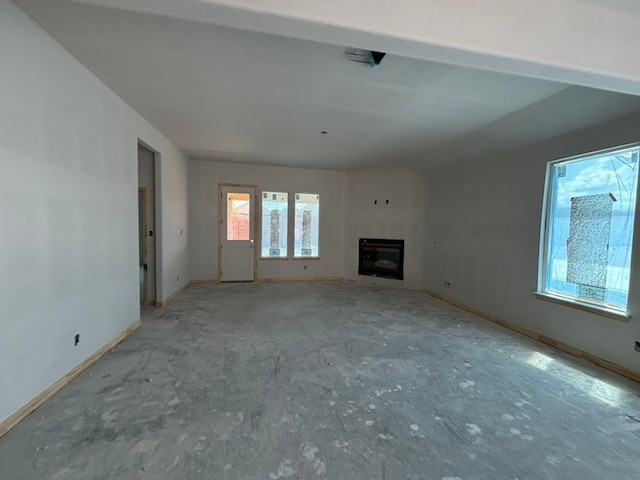 2017 Kelva Dr, Haslet, TX 76052 - unfurnished living room with a glass covered fireplace and baseboards