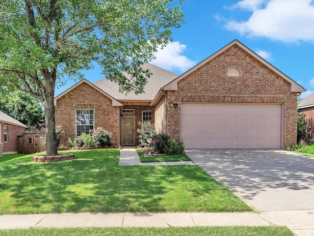 1928 Juniper Dr, Little Elm, TX 75068 - view of front of home with brick siding, a garage, roof with shingles, a front yard, and driveway