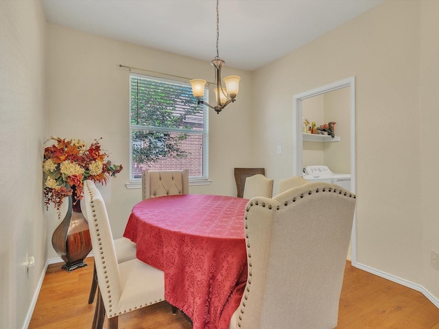 1928 Juniper Dr, Little Elm, TX 75068 - dining area featuring a chandelier, washing machine and clothes dryer, and light wood finished floors