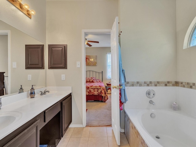 1928 Juniper Dr, Little Elm, TX 75068 - ensuite bathroom with double vanity, a garden tub, plenty of natural light, and tile patterned flooring