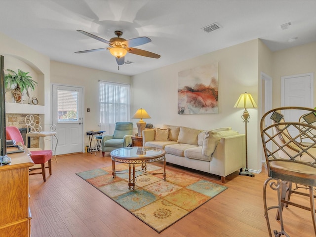 1928 Juniper Dr, Little Elm, TX 75068 - living area featuring light wood-style flooring, a ceiling fan, and a stone fireplace