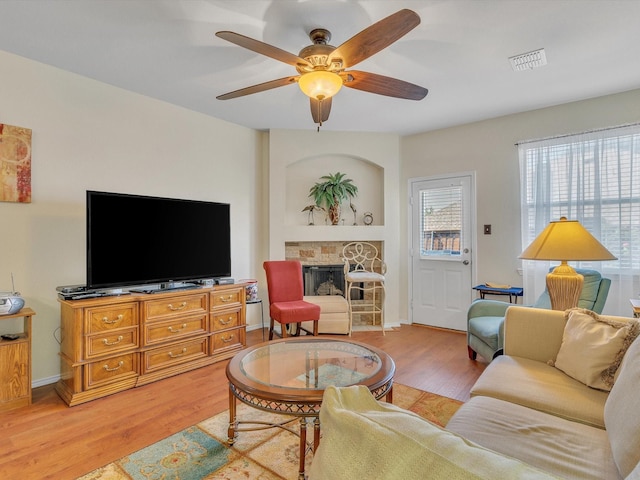 1928 Juniper Dr, Little Elm, TX 75068 - living room with light wood finished floors, a ceiling fan, and a fireplace