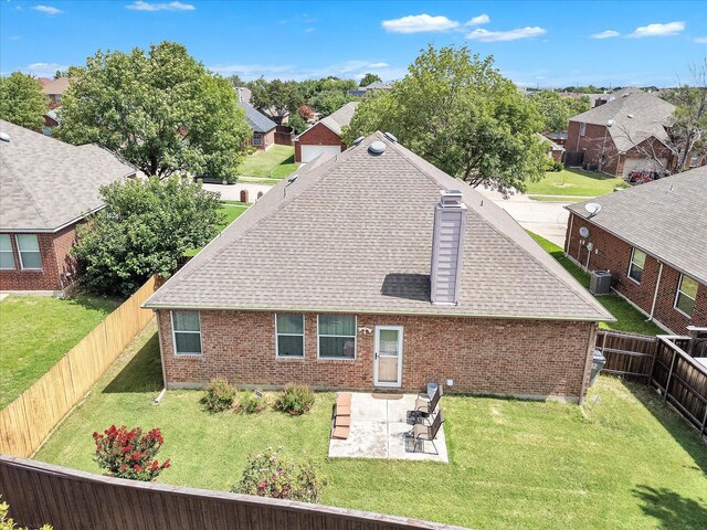 1928 Juniper Dr, Little Elm, TX 75068 - back of house with a shingled roof, brick siding, a chimney, a patio area, and a residential view
