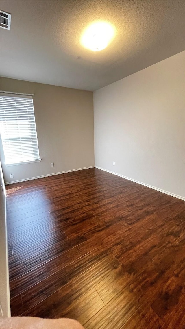 7811 Corona Ct, Arlington, TX 76002 - unfurnished room featuring dark wood-style floors and a textured ceiling