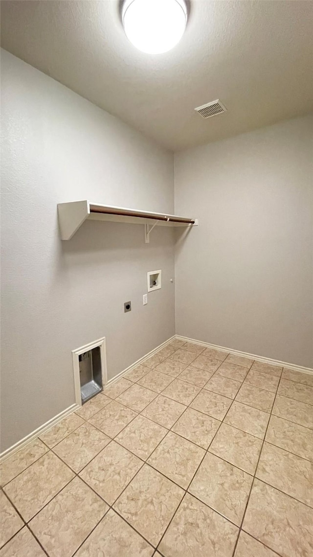 7811 Corona Ct, Arlington, TX 76002 - laundry area with hookup for a washing machine, hookup for an electric dryer, and light tile patterned floors