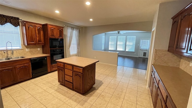 7811 Corona Ct, Arlington, TX 76002 - kitchen featuring black appliances, healthy amount of natural light, recessed lighting, arched walkways, and light tile patterned floors