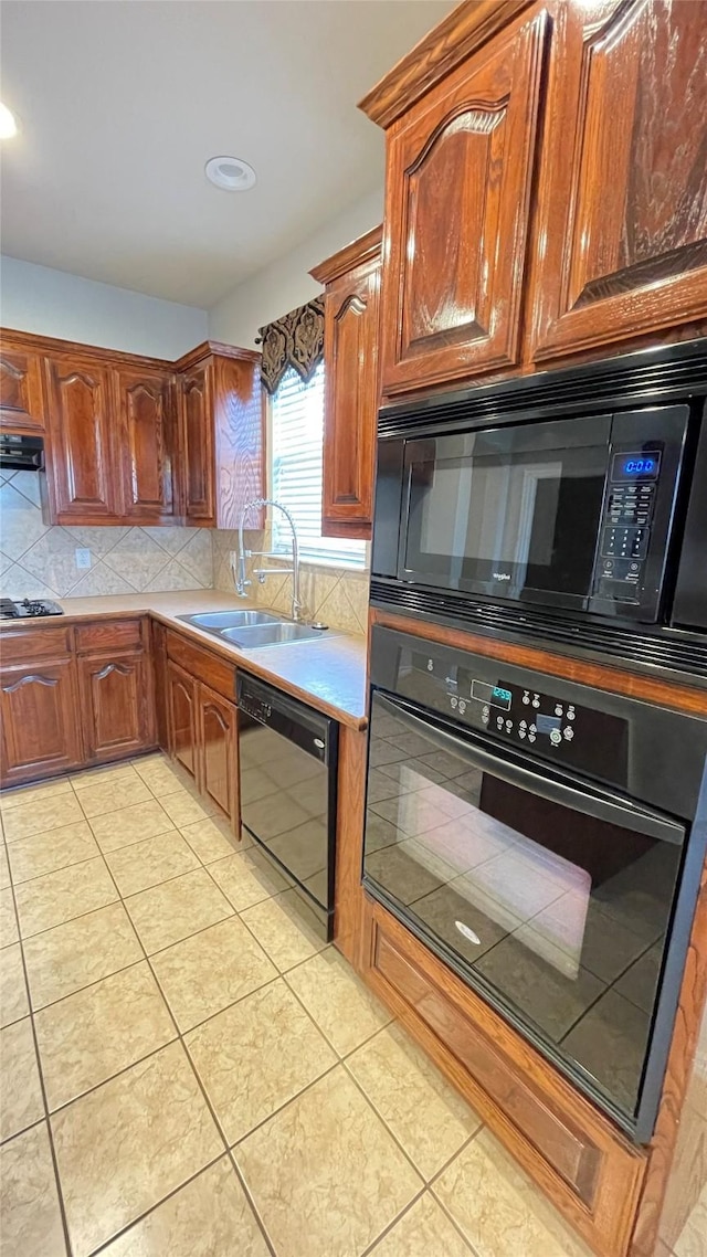 7811 Corona Ct, Arlington, TX 76002 - kitchen with black appliances, tasteful backsplash, light tile patterned flooring, light countertops, and extractor fan