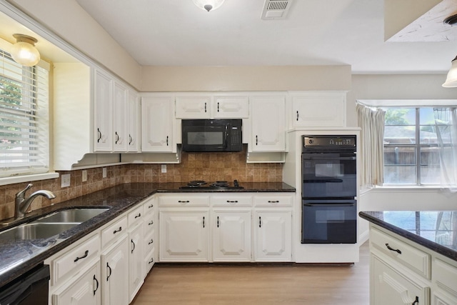 2709 S Hillbrier Cir, Plano, TX 75075 - kitchen featuring black appliances, light wood-style floors, white cabinetry, and decorative backsplash