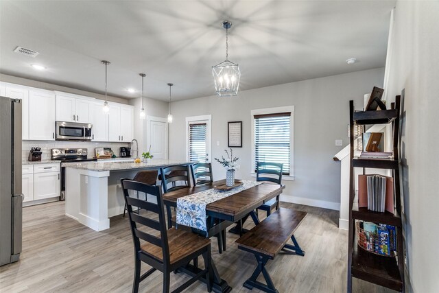 8916 Holt St, Lakeside, TX 76135 - dining area featuring light wood-style floors, a chandelier, and recessed lighting