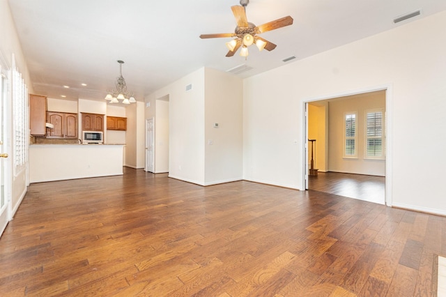 2248 Amy Ln, Plano, TX 75074 - unfurnished living room with a chandelier, dark wood-style flooring, ceiling fan, and recessed lighting