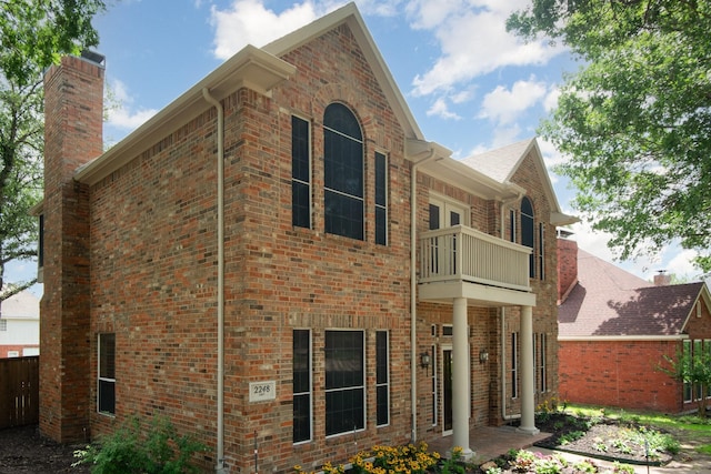 2248 Amy Ln, Plano, TX 75074 - rear view of house with a balcony and brick siding