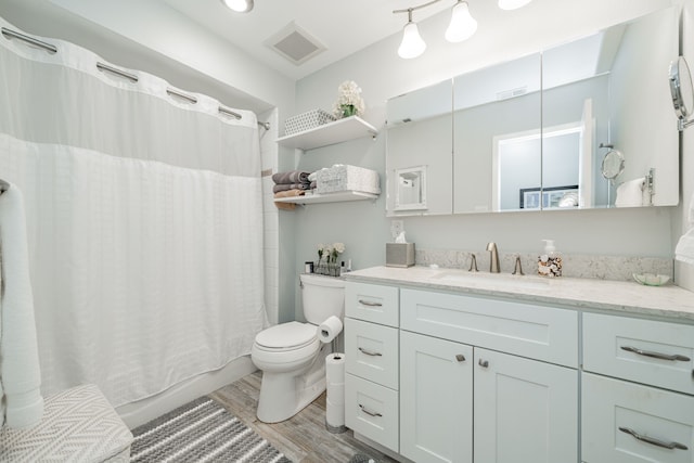 325 Los Santos Dr, Garland, TX 75043 - full bathroom with wood finished floors, vanity, and shower / bath combo