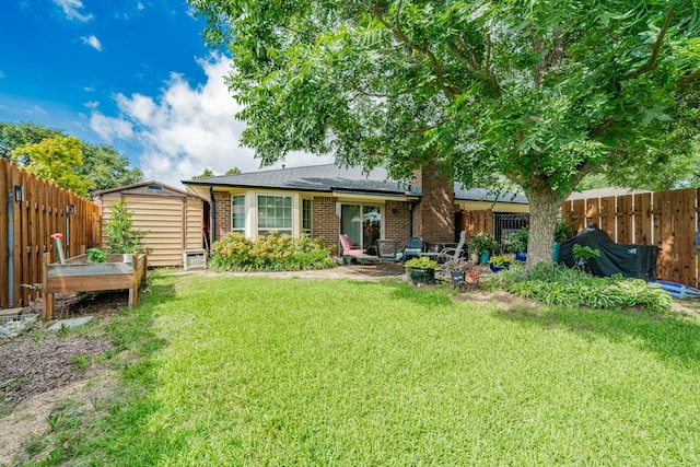 325 Los Santos Dr, Garland, TX 75043 - rear view of property featuring a storage unit, a fenced backyard, and brick siding