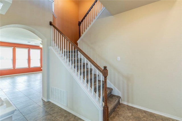 6600 Cascade Dr, Waco, TX 76712 - stairs with a ceiling fan, arched walkways, and tile patterned floors
