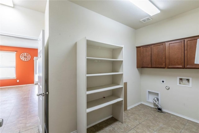 6600 Cascade Dr, Waco, TX 76712 - washroom with hookup for a gas dryer, electric dryer hookup, cabinet space, hookup for a washing machine, and light tile patterned flooring