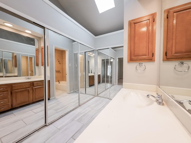 820 Via Madonna, Mesquite, TX 75150 - bathroom featuring a skylight, vanity, and bathing tub / shower combination