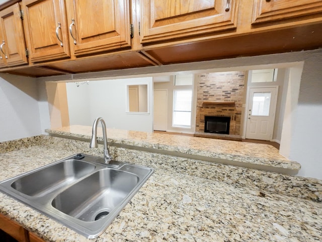 820 Via Madonna, Mesquite, TX 75150 - kitchen with plenty of natural light, light stone countertops, and a fireplace